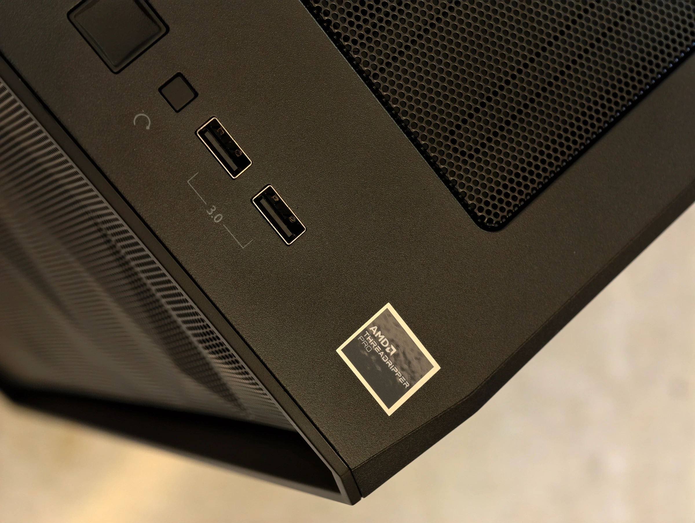Front top corner of the workstation chassis showing its high end desktop platform badge and front USB ports