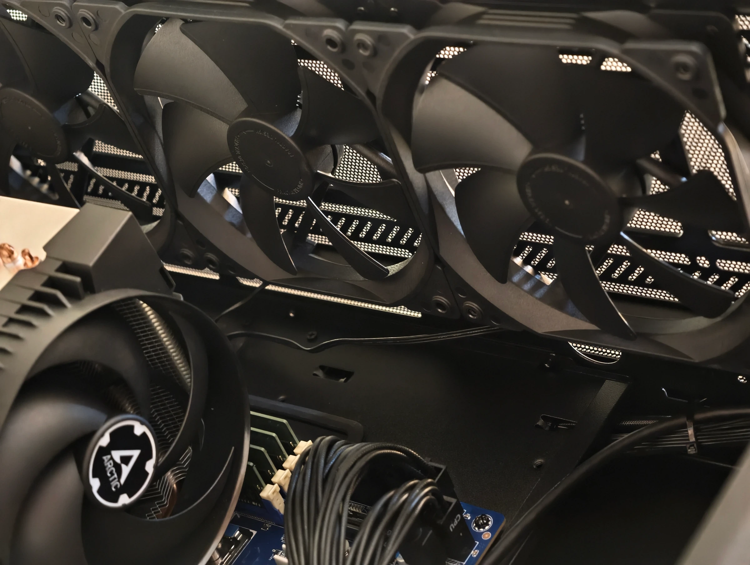 Angled view of the assembled interior showing case fans placed to draw air across the GPUs and the CPU cooler